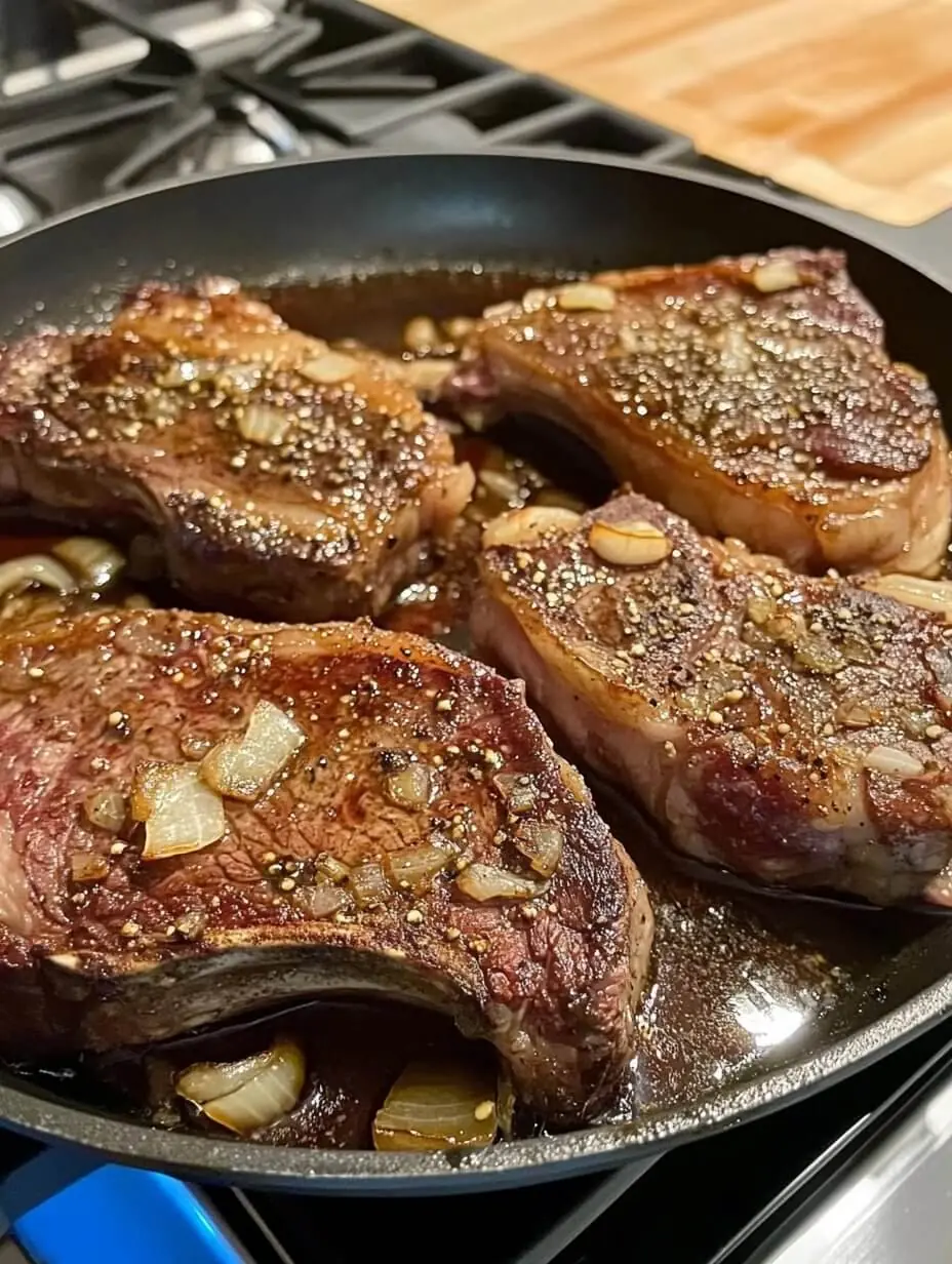 Rib-eye Steaks with Garlic Butter and Caramelized Onions